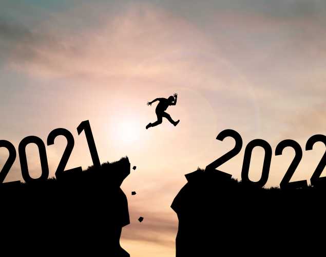 person leaping from 2021 cliff to 2022 cliff