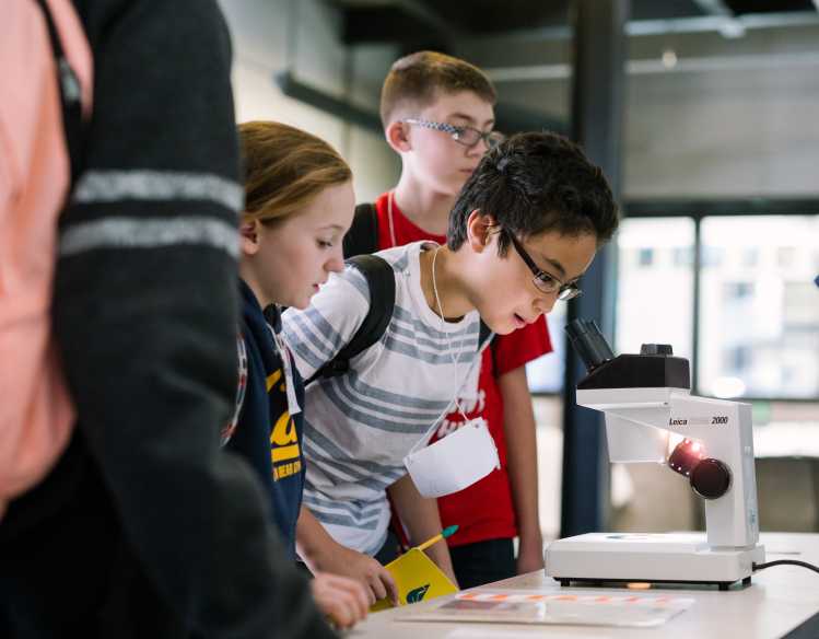 student looking into a microscope