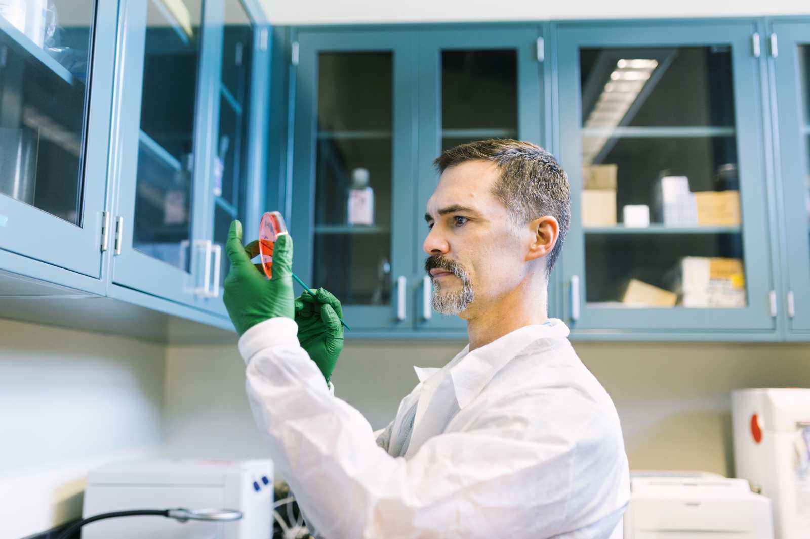 Carlos Rios looking at a sample in the laboratory