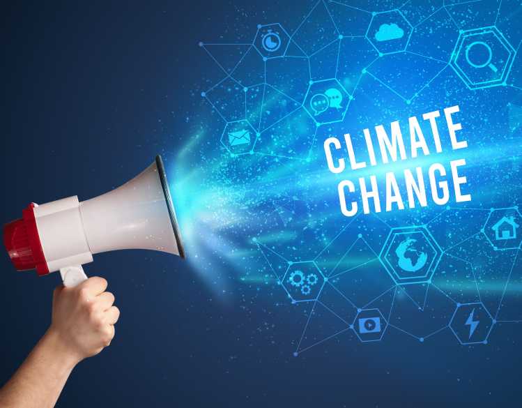 A hand holds a megaphone with the words “climate change.”