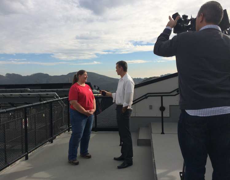 Dr. Cara Field talks to a reporter on camera