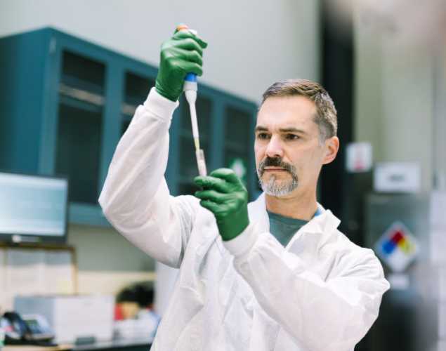 Carlos Rios holding a test tube